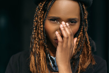 Shy young black female. Embarrassed girl. Stylish haircut, ashamed pretty woman covering face on...