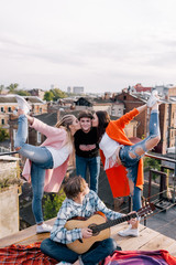Fototapeta premium Friends party on roof. Happy leisure time. Sport and music for young people, funny pastime outdoors