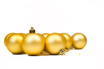 Gold Christmas balls with stars on white background.