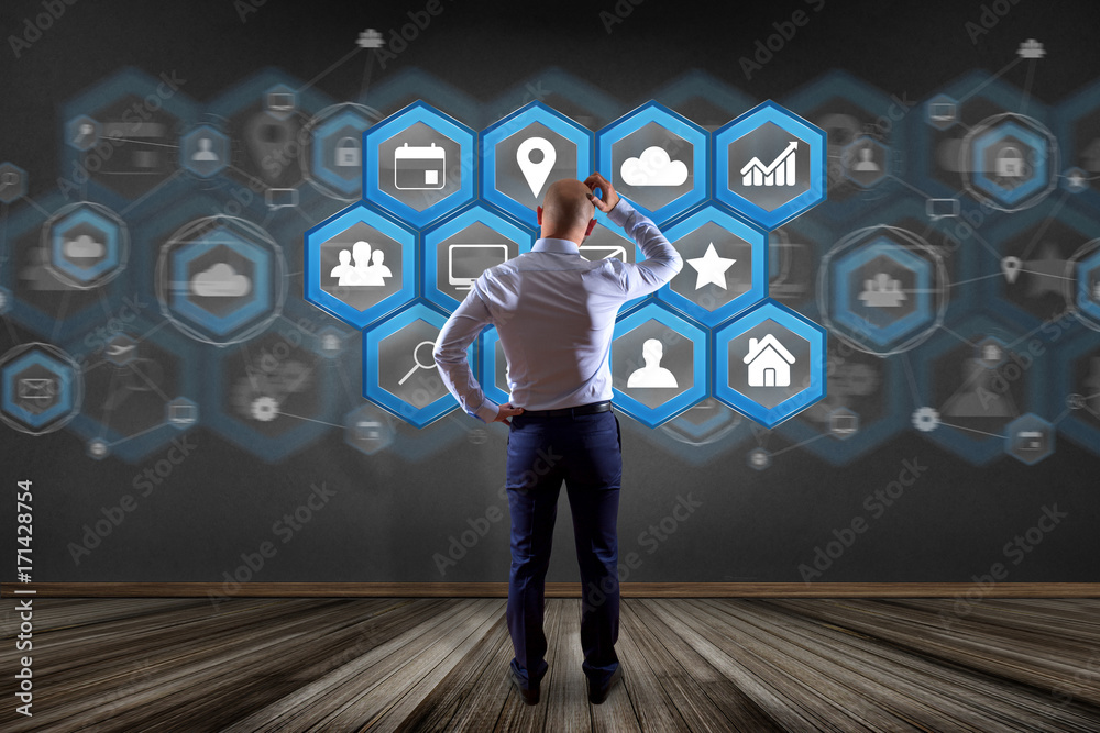 Poster businessman in front of a wall with application center displayed on a futuristic interface with tech