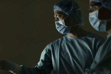 Two surgeons in dark