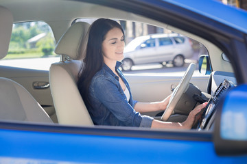 Attractive pretty woman staring her car