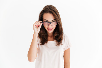 Pretty brunette woman in eyeglasses looking at the camera