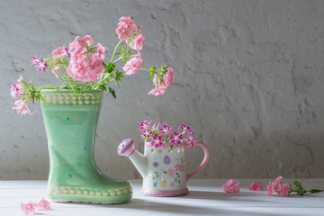 summer flowers in ceramic boot on white background