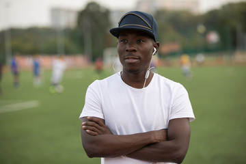 Confident african american male sportsman and trainer against stadium background