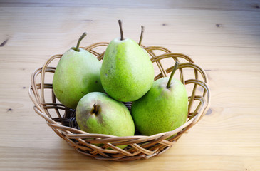 Ripe organic pears on a wooden table, top view.