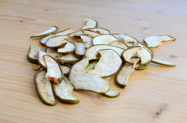 Ripe organic and dried pears on a wooden table, top view.