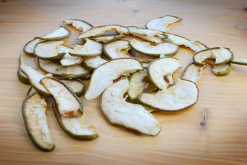 Ripe organic and dried pears on a wooden table, top view.