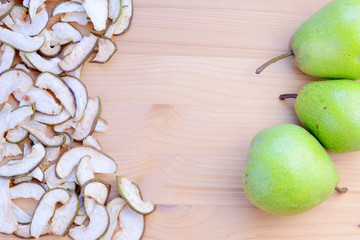 Ripe organic and dried pears on a wooden table, top view.