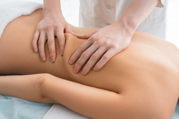 Fototapeta na wymiar Nude woman being massaged cropped view