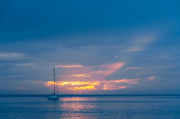 Sailing ship in the sunset off the Caribbean island of Dominica