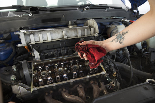 Woman's hand cleaning engine