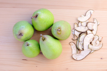 Ripe organic and dried pears on a wooden table, top view.