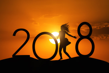 Silhouette woman jumping over 2018 on the hill at sunset