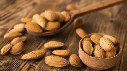 Food concept on healthy eating. Almond in wooden spoon over rustic table.