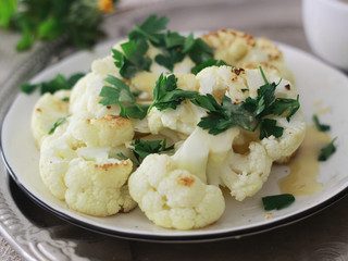 Roasted cauliflower with parsley and tahini dressing on a plate