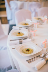 table set service with silverware and glass stemware at restaurant before party