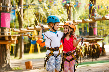 Obraz premium Smiling boy and girl playing when having fun doing activities outdoors. Happy childhood concept