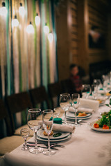 Beautifully decorated tables for guests with decorations and food. 
