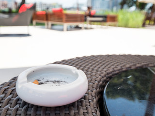 Closeup white ashtray with blur background