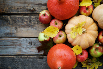 Autumn vegetables, fruites and leaves. Top view, rustic wooden background