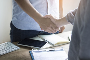 businessman shaking hands in office, concept as success in communication and teamwork in business.