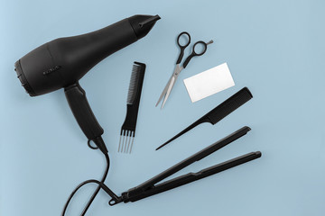 Hairdresser set with various accessories on blue background