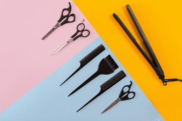 Hairdresser tools on a colored background with copy space