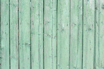 Obraz premium Green wooden background. Rough wooden painted background of boards. Fence close-up.