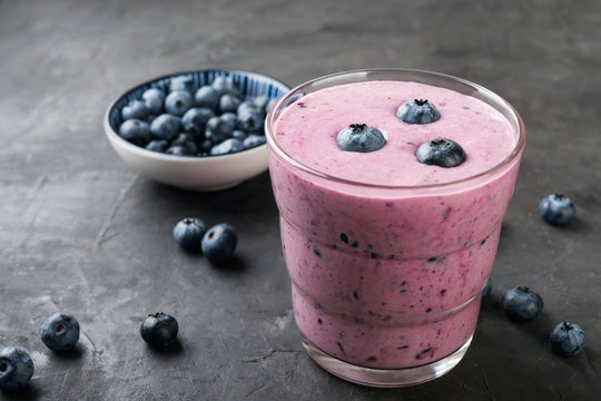 blueberry smoothie with  fresh berries on dark table