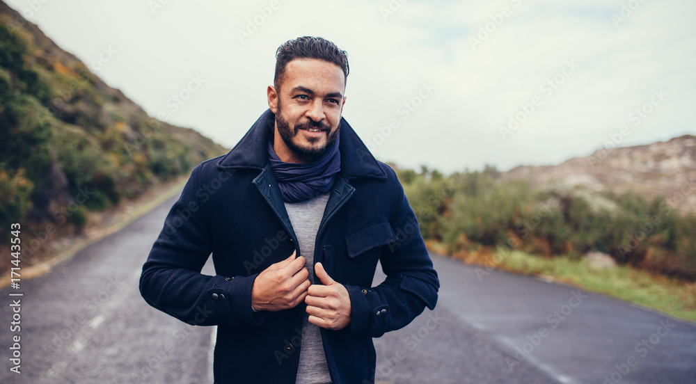 Canvas Prints Handsome man on rural highway on a winter day