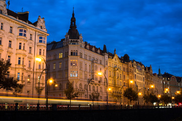Fototapeta na wymiar Prague, Czech Republic / Czechia - beautiful and decorated historic townhouses at Masaryk embankment are made in secession style. Residential architecture and lanterns during night