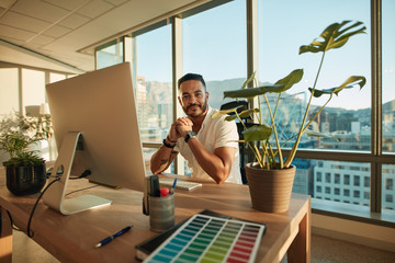 Handsome male entrepreneur sitting at his desk - Powered by Adobe