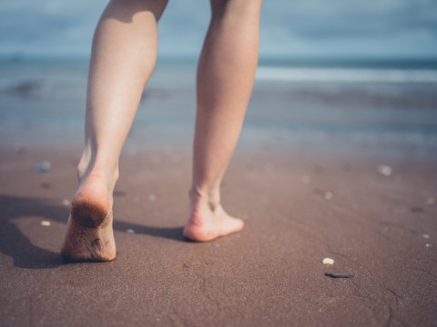 Young woman walking on the beach