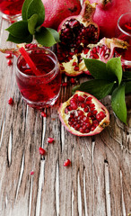 Fresh pomegranates and juice, selective focus