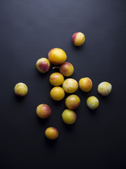 Fresh mirabelles plums isolated on black background