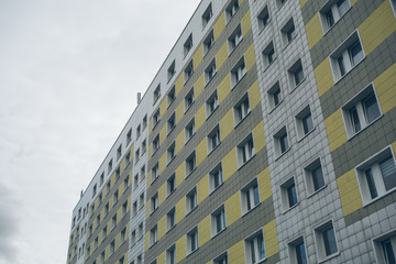 big plattenbau building with white and yellow facade