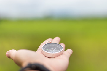 Compass on Human hand selective focus.