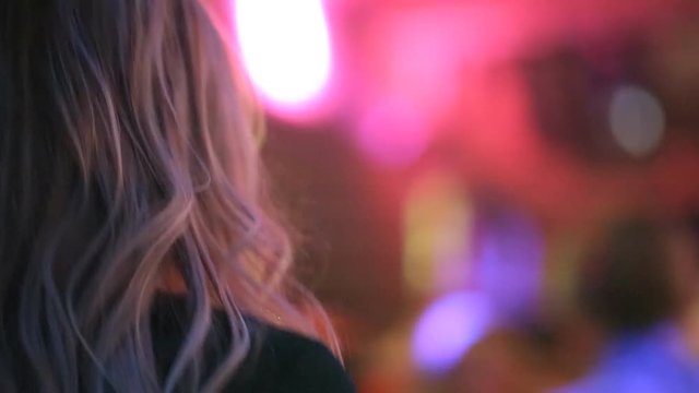 Young guys and girls are dancing in a nightclub at a New Year's party
