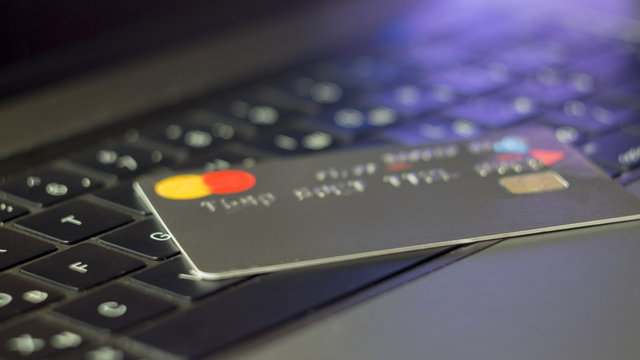 Credit cards on top of a laptop keyboard. Concept image for data breach, data security, e-commerce, credit card online use, data encryption. Selective focus.
