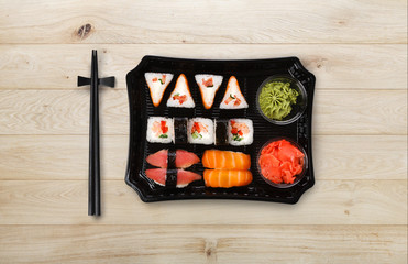 Japanese food delivery. Set of sushi and rolls top view on wood
