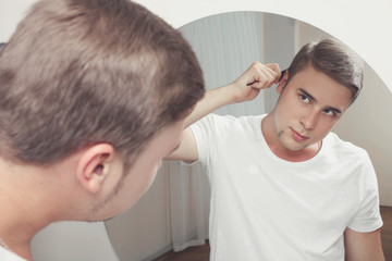 Fototapeta premium man combing his hair