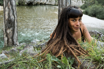 Beautiful hippie girl at an alpine river in Austria