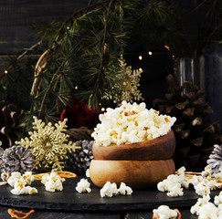 popcorn in a wooden plate on the background of Christmas