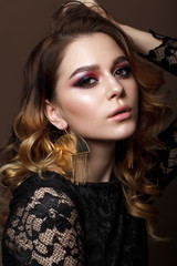 Beautiful young woman with evening makeup and wavy hairstyle. Purple smoky eyes
