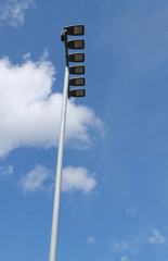 A Bank of Large Street Floodlights on a Tall Post.