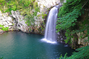 Fototapeta na wymiar The Cheonjeyeon Waterfall on Jeju Island in South Korea 