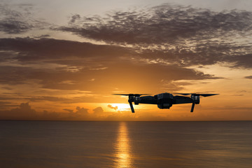 Fototapeta na wymiar Silhouette drone against the sunset