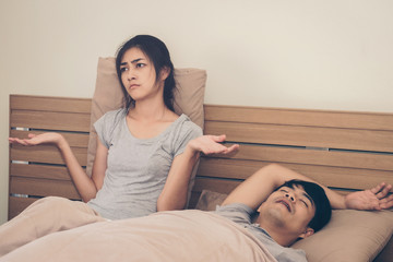 A woman has a nuisance to the man he loves sleeping loud snoring.Concept of life together