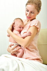 Mother and baby. Happy family. Home interior.